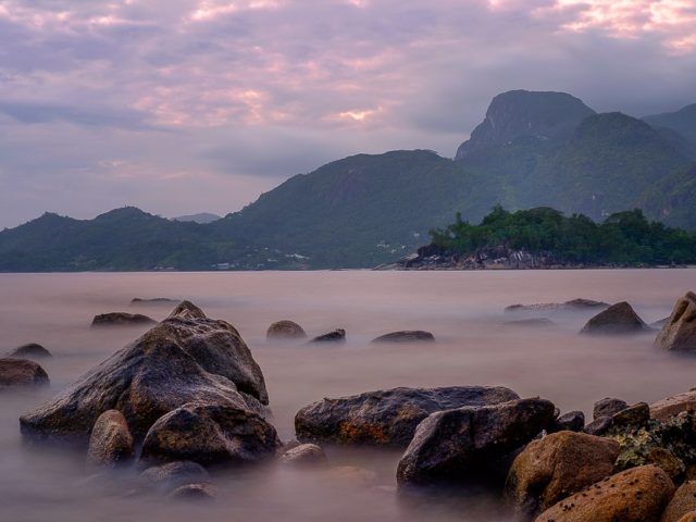 Long exposure of sea and boulders on Barbarons Beach in Seychelles